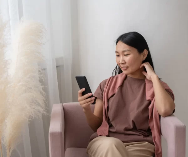 young-smiling-asian-woman-in-casualwear-sitting-in-2022-02-23-02-09-38-utc